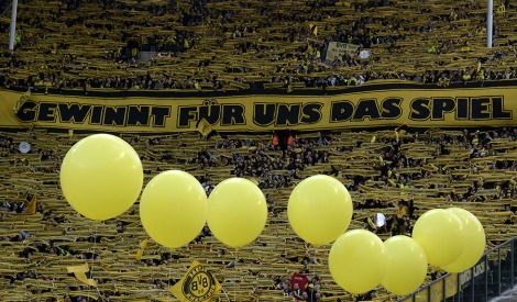 Supporters of Borussia Dortmund hold up their scarves to cheer their team prior to the German cup " DFB Pokal " final football match Bayern Munich vs Borussia Dortmund at the Olympiastadion in Berlin on May 12, 2012. AFP PHOTO / ODD ANDERSEN (Photo credit should read ODD ANDERSEN/AFP/GettyImages)